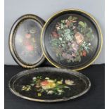 Three papier mache trays, each painted with floral groups.