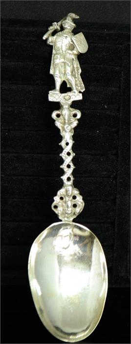 A continental silver spoon, with sword wielding knight surmounting the handle, and a coat of arms