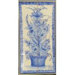 A set of Delft blue and white tiles, set on a board to depict a flowering plant.