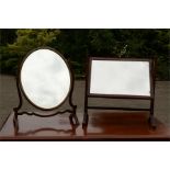 Two Edwardian mahogany toilet mirrors, one in oval form, one rectangular.