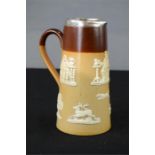 A Doulton stoneware glazed jug with silver rim, and raised hunting decoration.