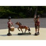 Three wooden painted figures; Scottish Guard, drummer and a horse.
