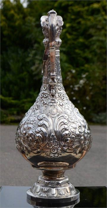 A silver claret jug, embossed with floral decoration, with presentation inscription to the front, - Image 4 of 7