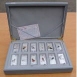 A boxed set of Chinese white metal ingots; signs of the Zodiac.