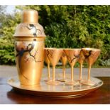 A Japanese gilt lacquered tray with cocktail shaker and six glasses, each hand painted with a