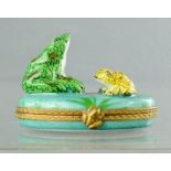 A Limoges frog pill box, modelled with three frogs in a pond.