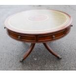 A mahogany drum table with green leather top.