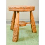 A carved oak table/stool in the manner of Peter Heap.