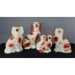 A group of five Staffordshire dogs, of various size, together with two Staffordshire pastille