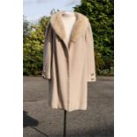 A Felix Fashions beige/camel colour coat with fur collar, approx size 10.