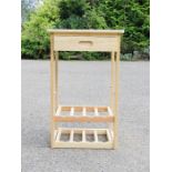 A beech kitchen wine rack with drawer.
