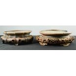 Two Chinese carved stands, one in the lotus design 30cm diameter, the other carved with pierced