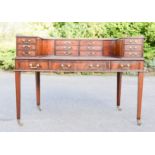 A fine mahogany Carlton House desk, the curved upper section with brass gallery rail, series of