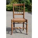 An oak and elm single chair by F. Thomas, bearing makers label under seat.