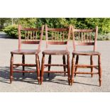 Three spindle back chairs.
