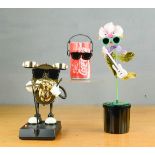 Three 80s toys; dancing Coca Cola, dancing flower and drum.