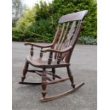 A 19th century elm Windsor rocking chair.