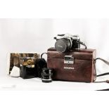 An Olympus camera OM2 with two Vivitar lenses and case.