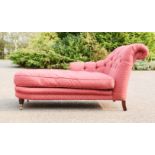 A chaise longue, upholstered in red fabric.