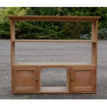 A pine wall shelf, with two shelves above two cupboard doors.