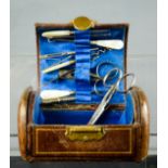 A Victorian leather bound sewing box, with contents and silk blue lining, together with a pair of