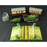 A Hornby tin group; Locomotive, two carriages, crossing and train stop.