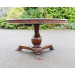 A William IV mahogany breakfast table, the circular top raised on a baluster column base, and