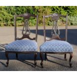 A pair of Edwardian nursing chairs, blue upholstered seats.