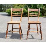 A pair of 19th century elm chairs, with bobbin backs and figured seats.