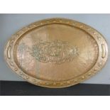 An Arts & Crafts copper dish, oval form, 74 by 47cm.