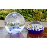 Two glass paperweights, one mille fiori, 8cm diameter.