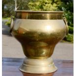 A large brass jardinere/bucket, with hoop handles, 38cm high.