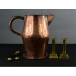 A pair of brass candlesticks, an early copper jug, and a pair of iron and brass curtain hooks.