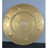 A brass charger, with tudor rose embossed to the centre.