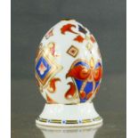 A Royal Crown Derby egg on stand.