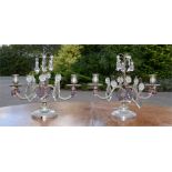 A pair of table candleabra with cut glass drops.