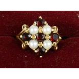 A 9ct gold garnet and pearl ring, size O, 5.4g.