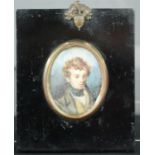 A 19th century miniature oil painting depicting a young boy.