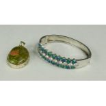 A silver bangle with diamante and faux-opals together with a silver and agate pendant.