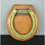 A brass horse shoe door knocker.