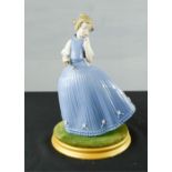 A Lladro figure of a young girl wearing blue gown, 27cm high.