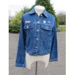 A women's Essentials size 10 denim jacket, with three Elvis badges and two pictures of Elvis to