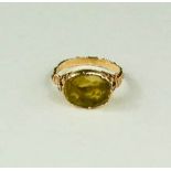 A Georgian citrine ring, foil backed, corner copia motifs to the shoulders, size Q/R, 5g.