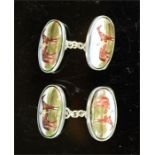 A pair of silver cufflinks, with enamelled ovals painted with a racehorse and jockey.