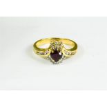 An 18ct gold, diamond and garnet ring, marked 750, 3.6g.