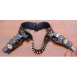 A Western double holster with metal embellished leather and bullet holders