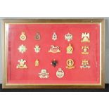 A group of military badges in a box frame.