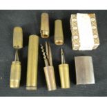 A group of brass cases enclosing various tool heads; possibly trench tools, together with razor