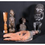 Four carved African figures including a wrapped fetish torso and an Ivory Coast Fante carved figure