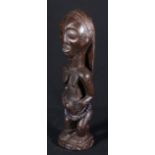 DRC standing carving of a female fertility figure, scarified face and bead decoration to the waist,